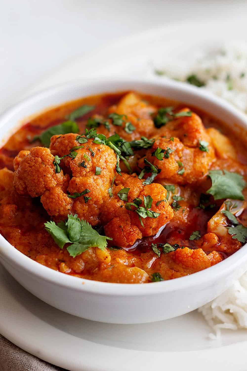 Here's a delicious "clean-the-fridge" vegetable tikka masala recipe that you'll love. Learn how to make a tasty vegetarian tikka masala with just a few ingredients and an easy shortcut. This cauliflower tikka masala is full of flavor and will knock your socks off! 