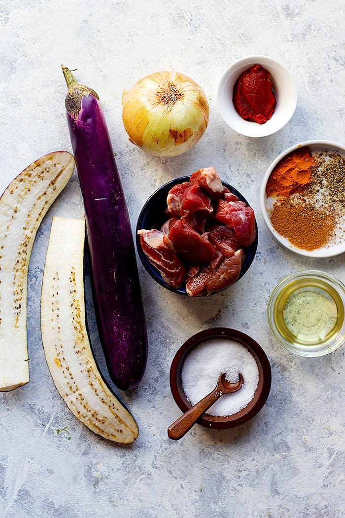 Ingredient shot for khoresh bademjan. You need oil, onion, lamb, spices, tomato paste and eggplants. 