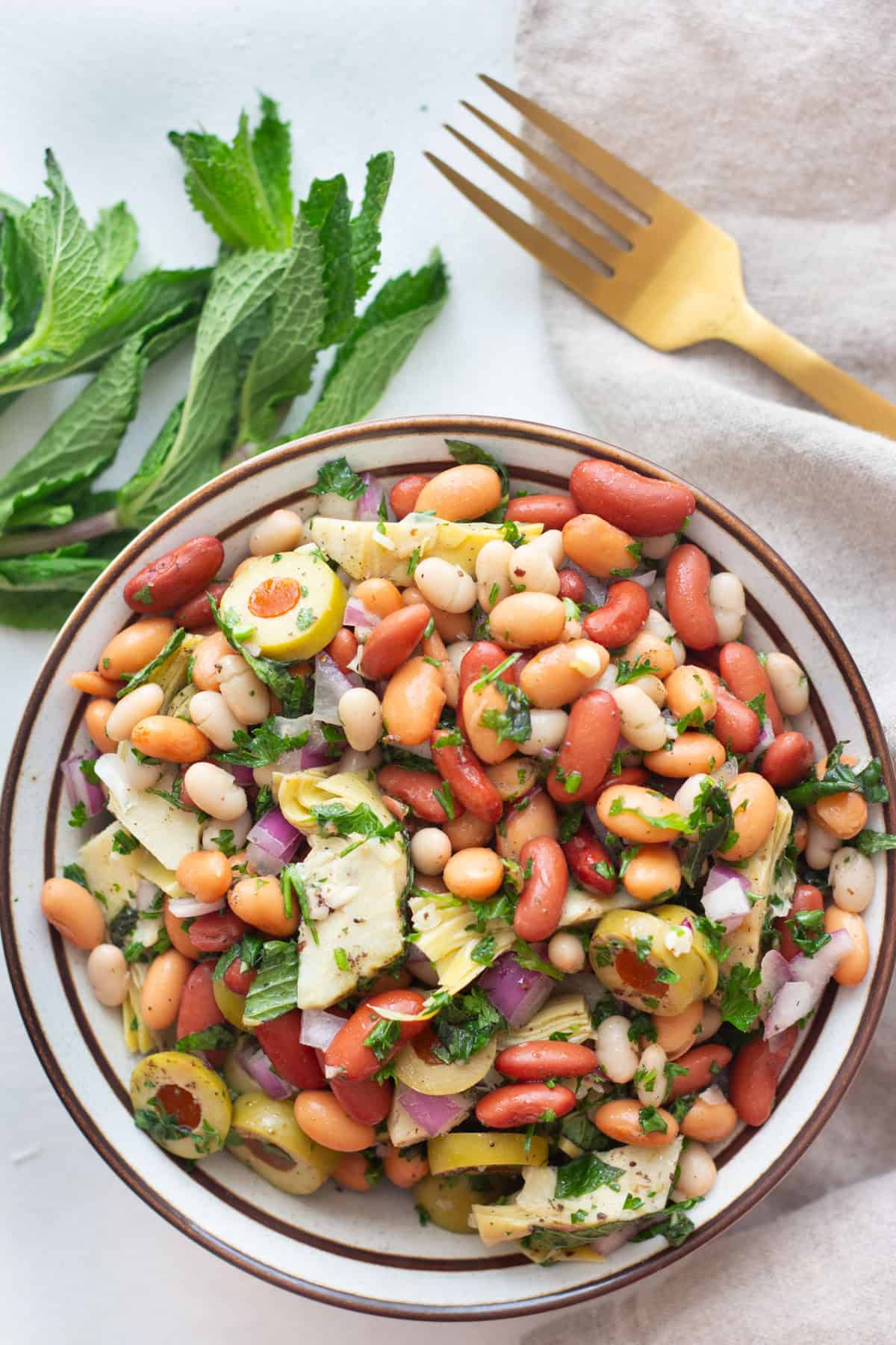 An easy three bean salad recipe with a Mediterranean twist. This protein-packed vegan salad is perfect for meal prep or as a side dish. Make sure to watch the video for step-by-step instructions.&nbsp;