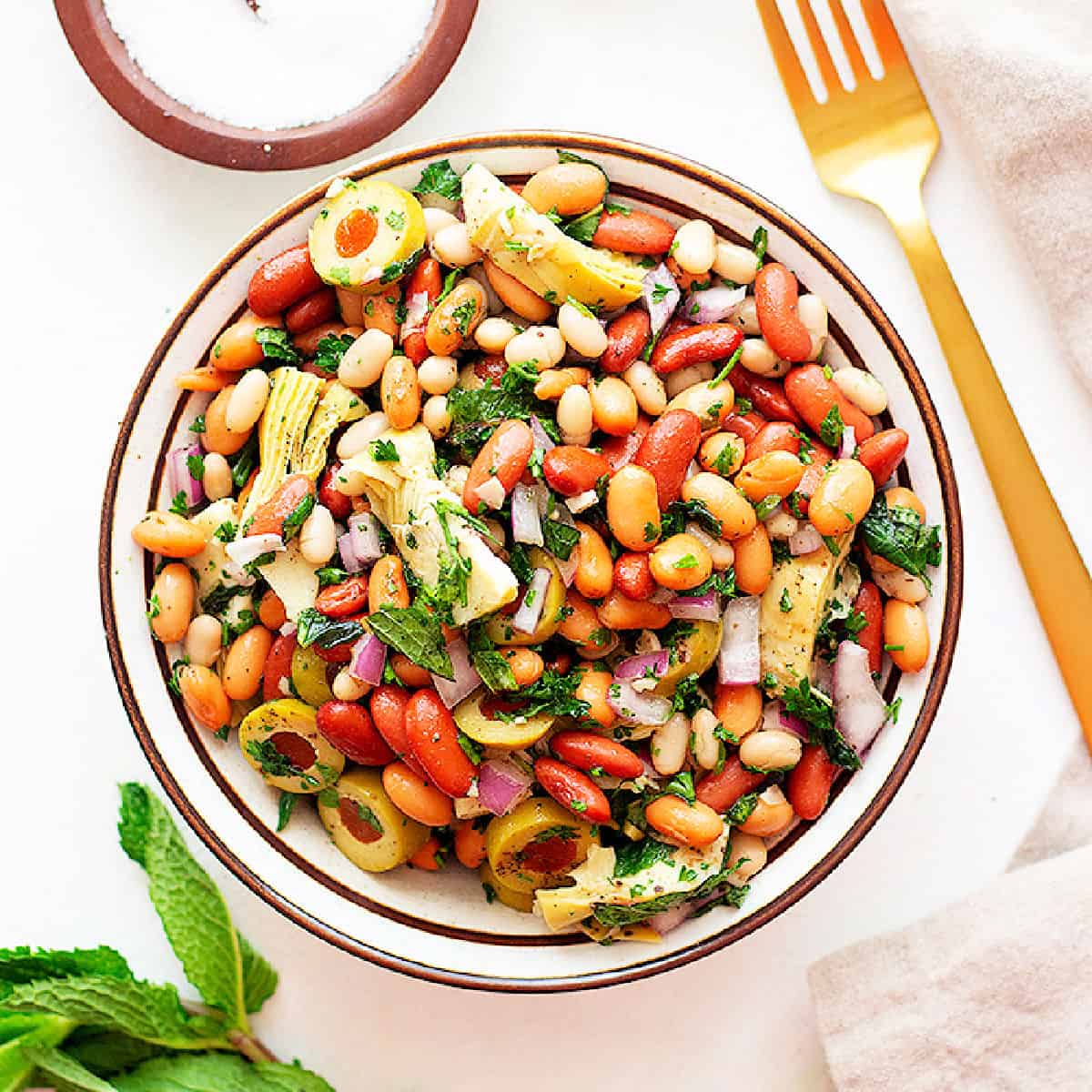 An easy three bean salad recipe with a Mediterranean twist. This protein-packed vegan salad is perfect for meal prep or as a side dish. Make sure to watch the video for step-by-step instructions. 