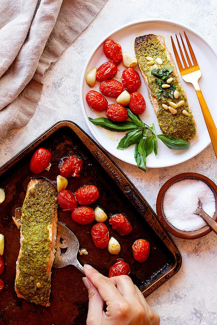Bake the salmon on a baking sheet with tomatoes and garlic. Serve with some fresh basil and pine nuts. 