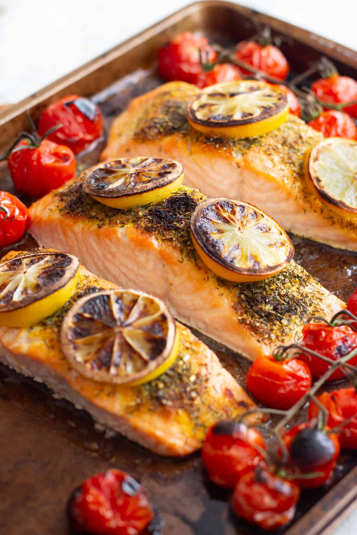 broiled salmon recipe made with salmon fillets and spices on a baking sheet.