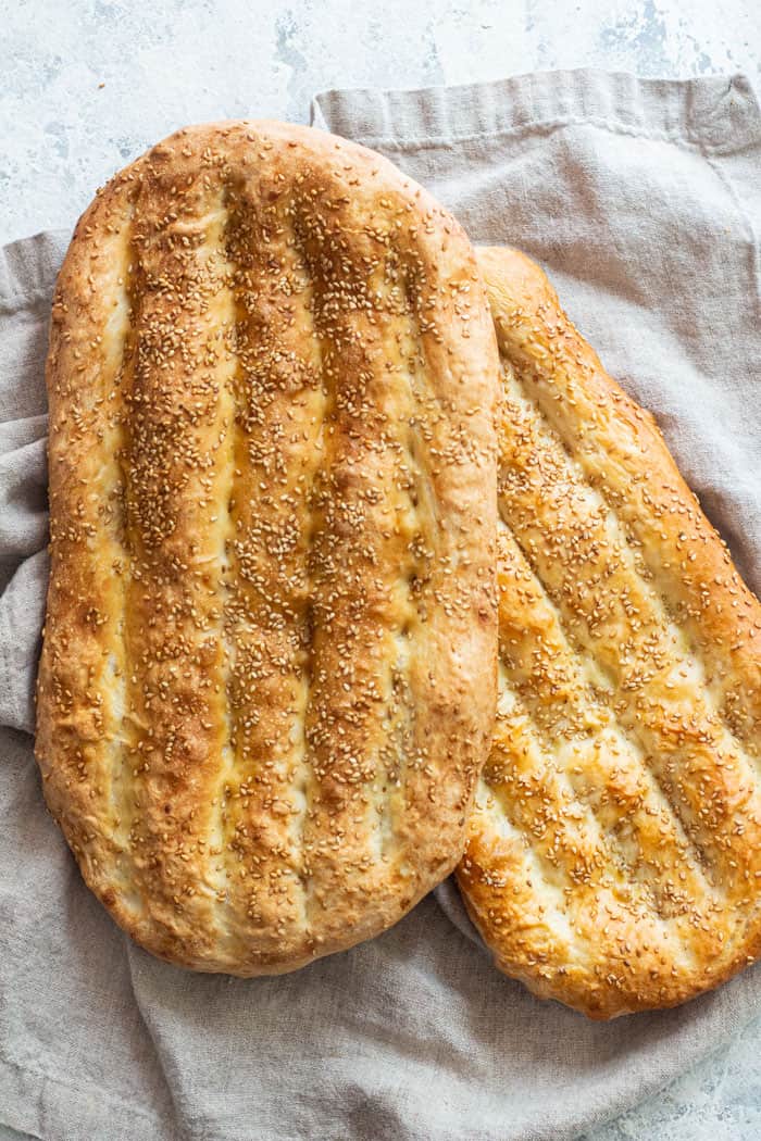 Two loaves of barbari on a background.