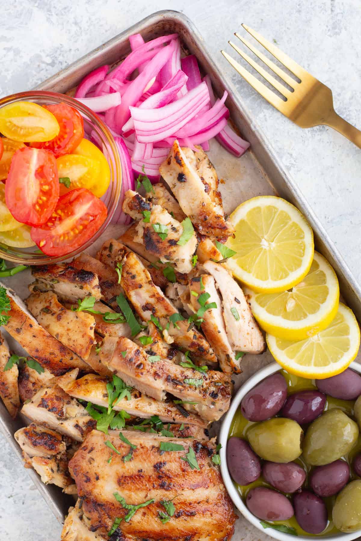 Serve the chicken with some tomatoes, onions and olives.