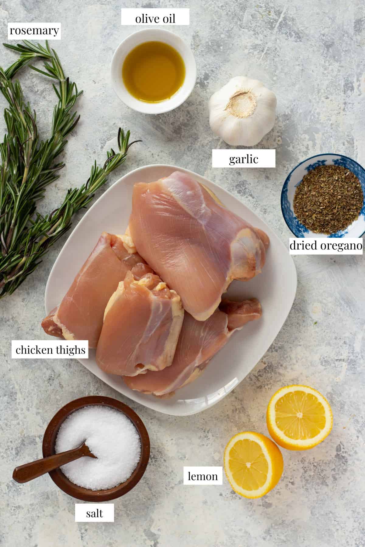 Ingredients to make garlic chicken are chicken thighs, lemon, sat, olive oil, oregano, garlic and rosemary.
