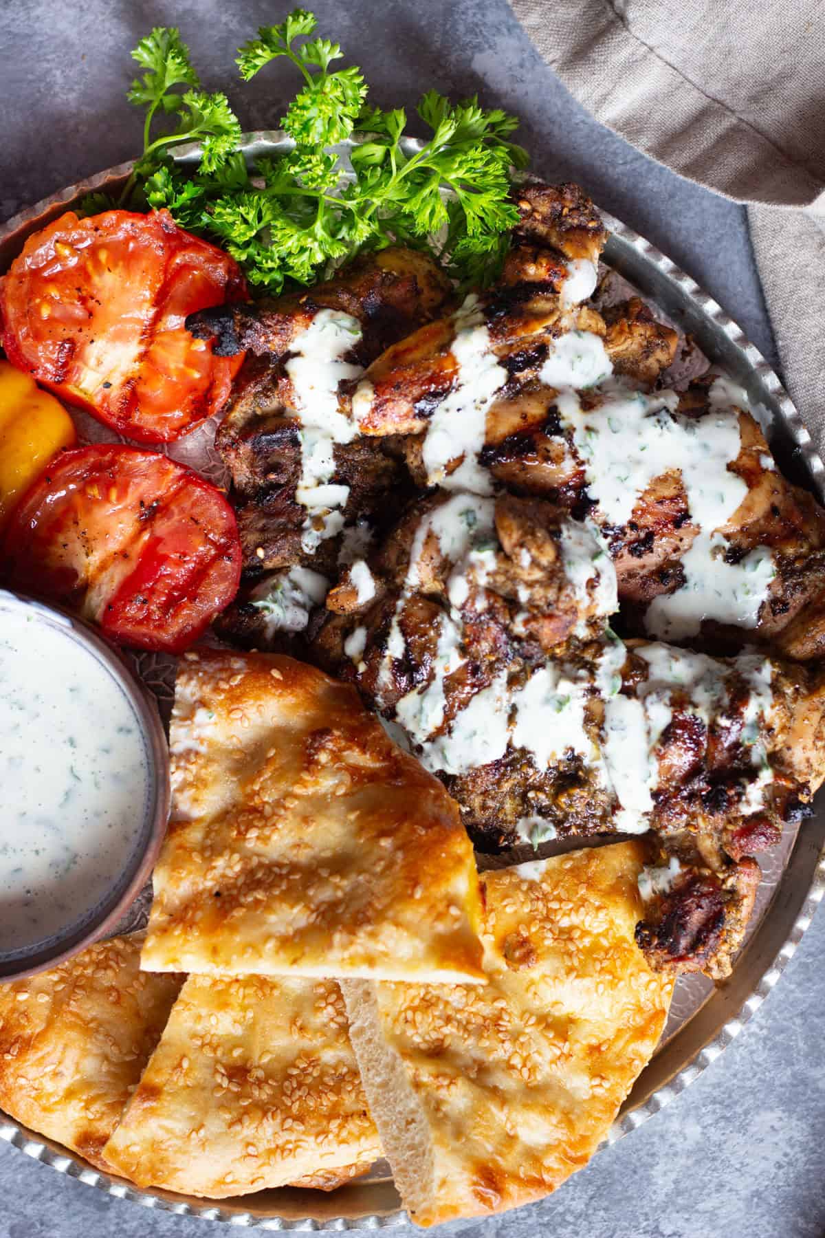 Serve grilled zaatar chicken with grilled vegetables and a  yogurt sauce. 
