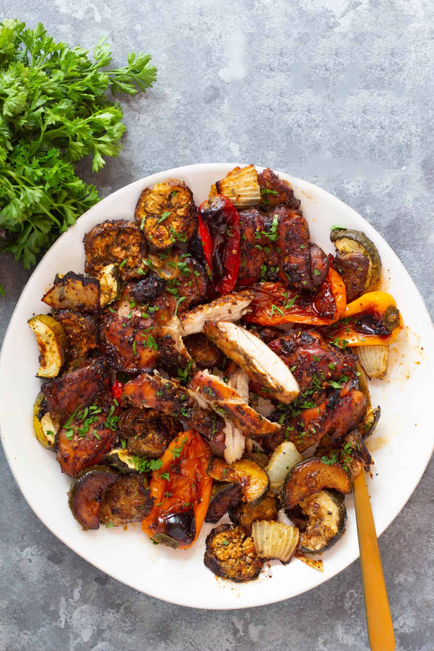 A platter of balsamic chicken with veggies. 