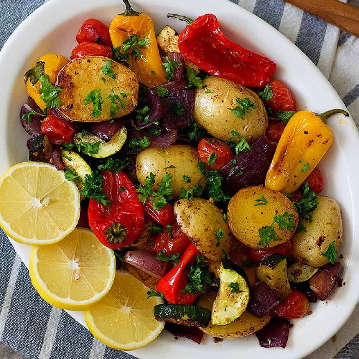 Mediterranean style oven roasted vegetables are so simple, yet hearty and delicious. They make for a wonderful side dish that's packed with flavor.