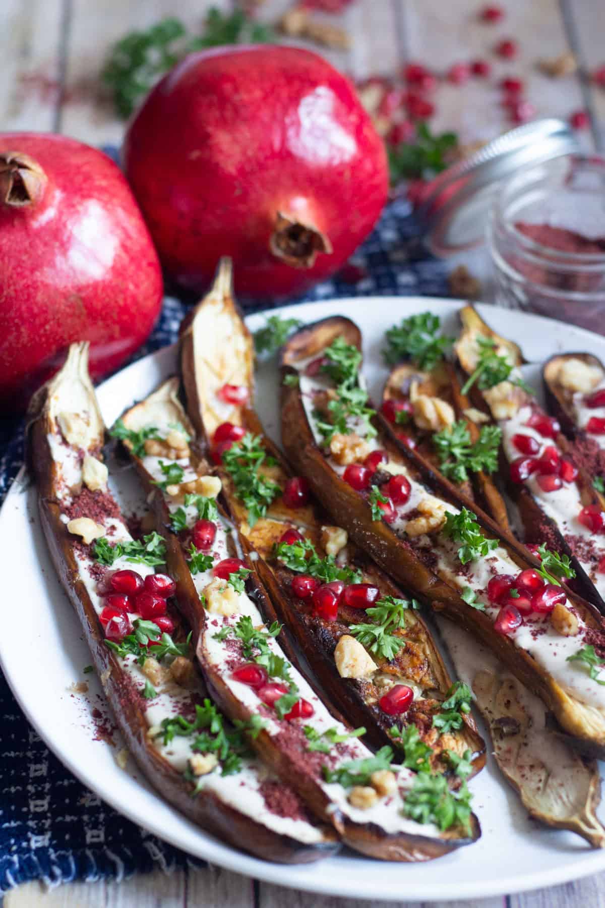 Oven Roasted Middle Eastern Eggplant with sumac, yogurt tahini sauce, pomegranates and walnuts.