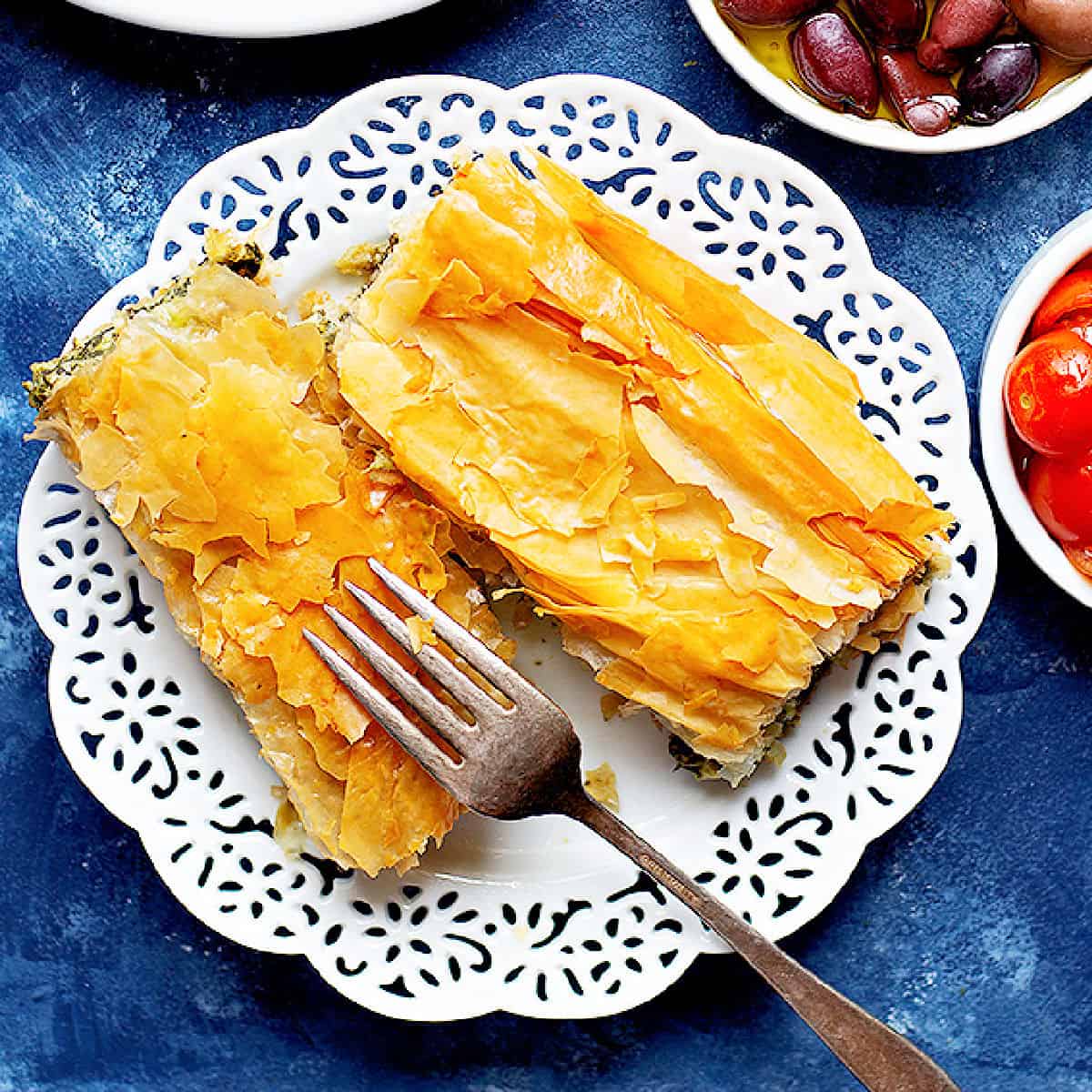 spanakopita on a white plate. 