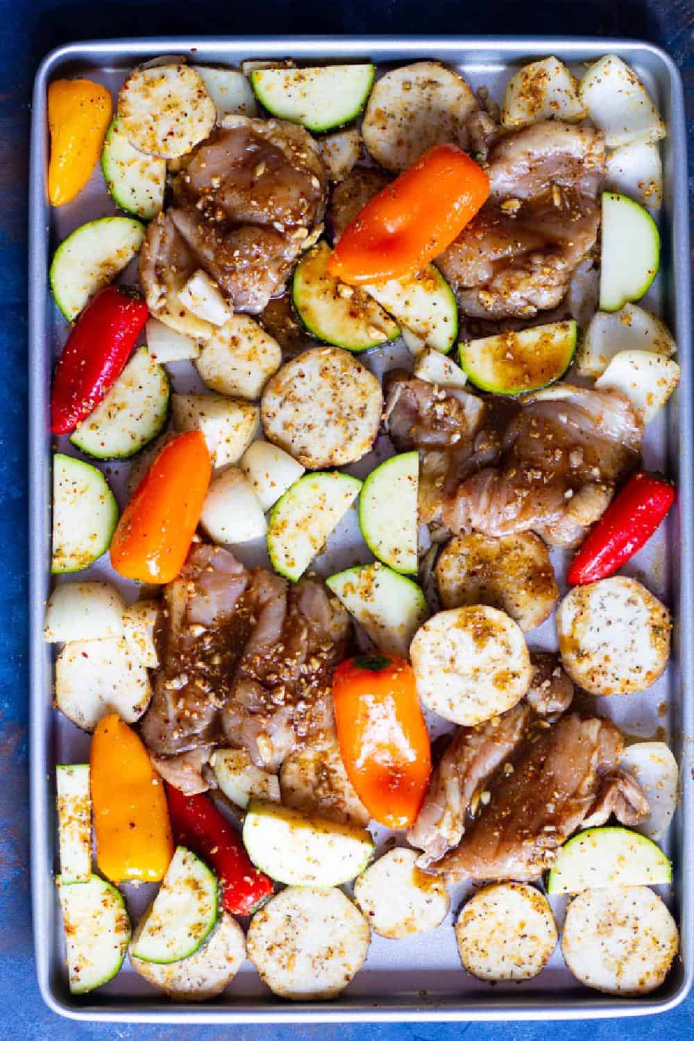 One all the chicken and vegetables are marinated, place them on a sheet pan and bake in the oven.