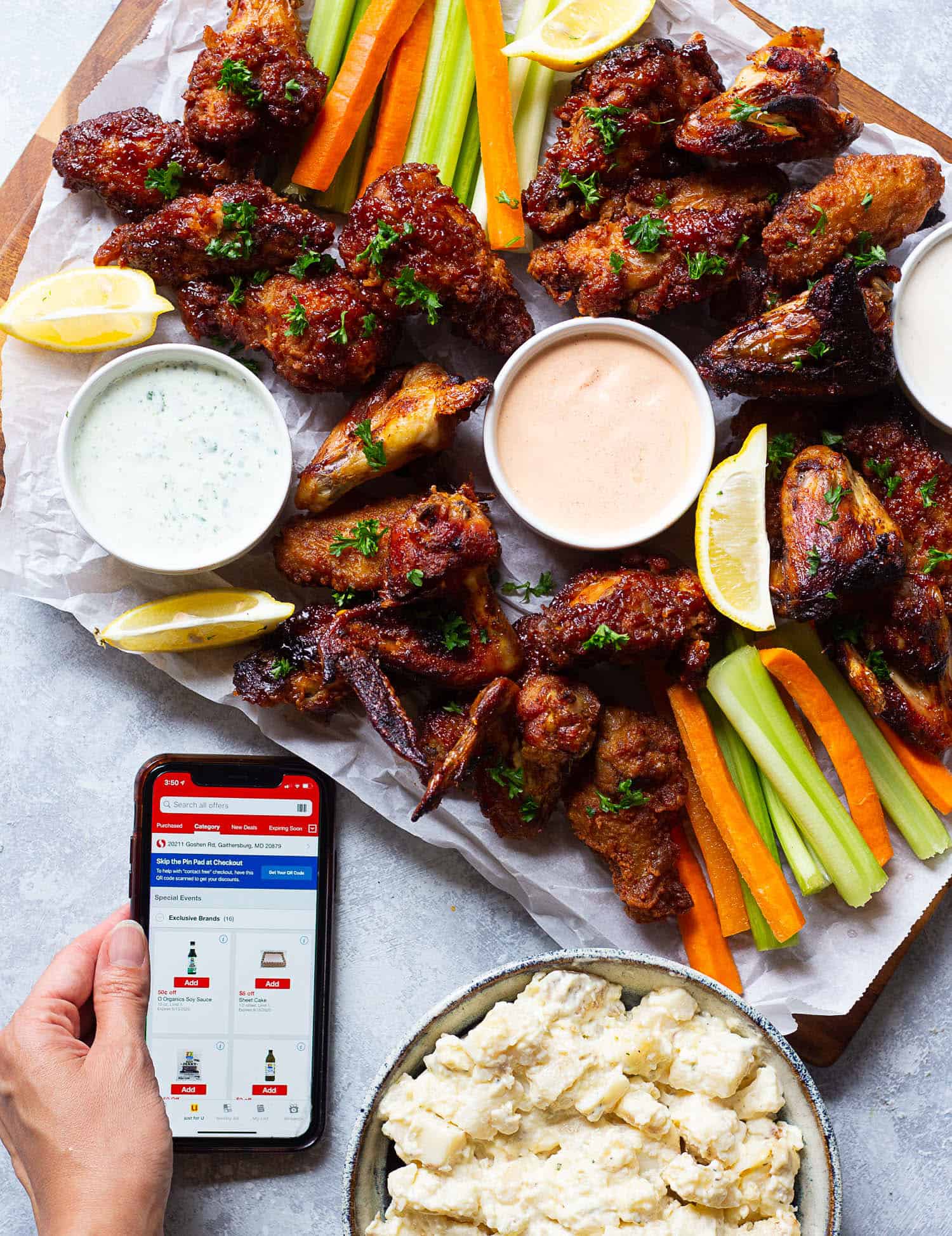 On a chicken wing board place the sauces, carrots and celery. 