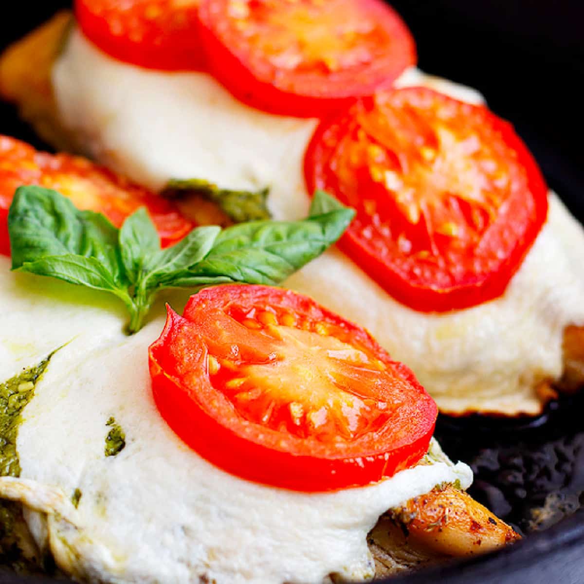 Easy caprese chicken recipe that's ready in only 30 minutes. Made with fresh tomatoes, mozzarella and pesto, this is a delicious easy weeknight dinner. Learn how to make this easy chicken recipe at home with our video and step-by-step tutorial. 
