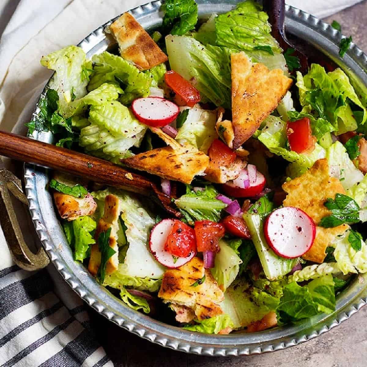 This authentic Lebanese fattoush salad is a Middle Eastern classic. Fresh chopped salad is flavored with crispy toasted pita and a bright, zesty dressing.
