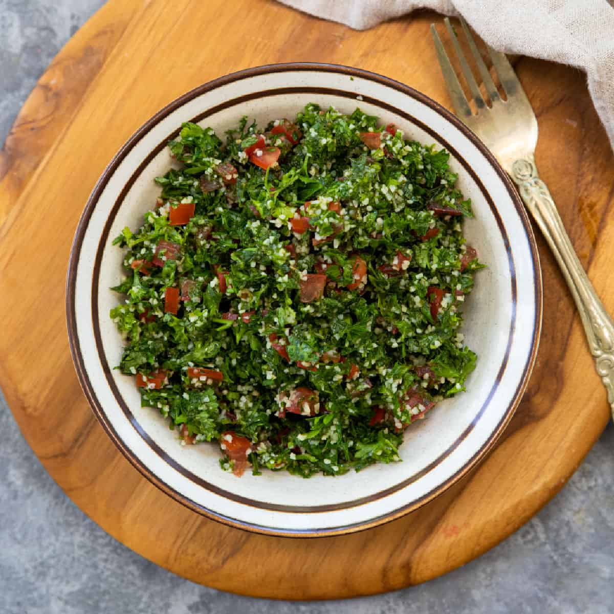 Tabouli, also known as tabbouleh, is a beautiful Middle Eastern salad that's very simple to make. Fresh tomatoes, and finely chopped herbs, mixed with bulgur, lemon juice, and olive oil, are the ingredients of this simple yet delicious salad. This salad is ready in 20 minutes.
