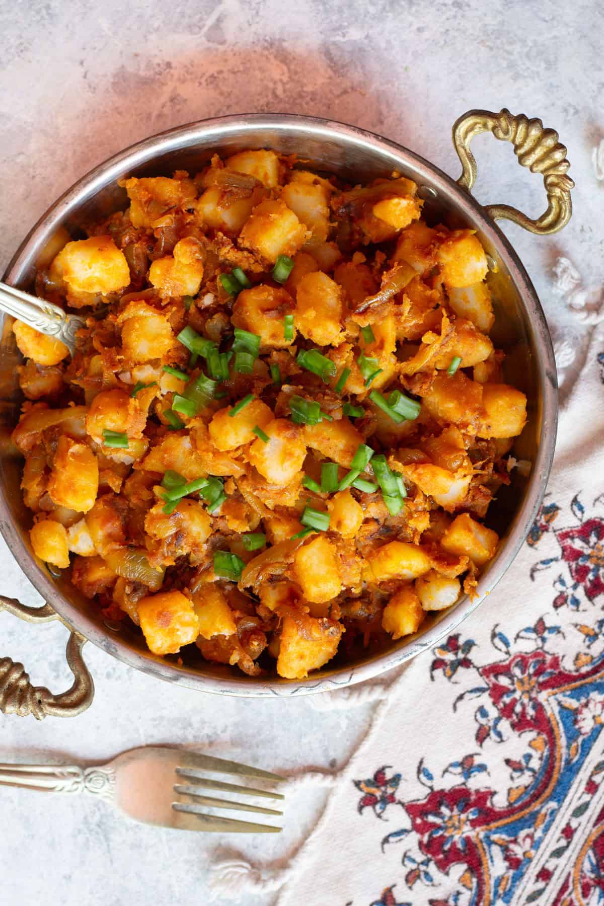 Top fried potatoes and onions with green onions or parsley for more flavor. 