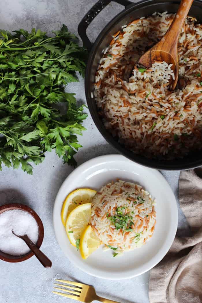 A pot of fluffy rice pilaf and herbs. 