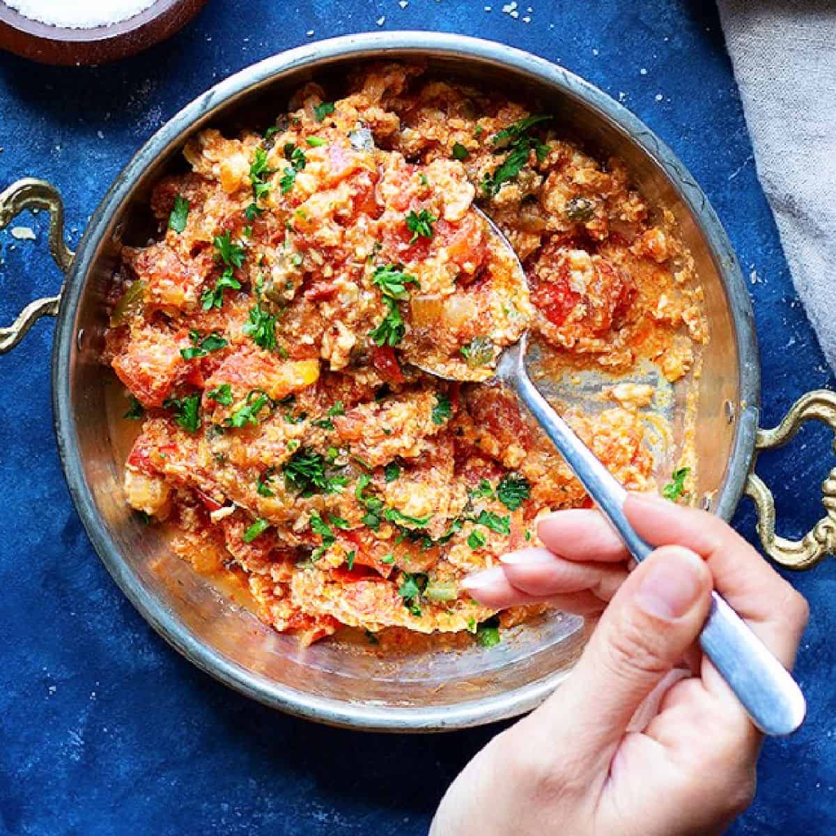 Menemen is a traditional Turkish breakfast recipe made with tomatoes and eggs. Learn how to make it at home with a few ingredients.  
