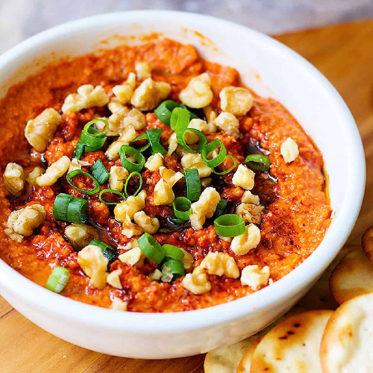 Muhammara is a tasty roasted red pepper dip from Aleppo, Syria. This classic Muhammara recipe is made with roasted red peppers, walnuts and olive oil.