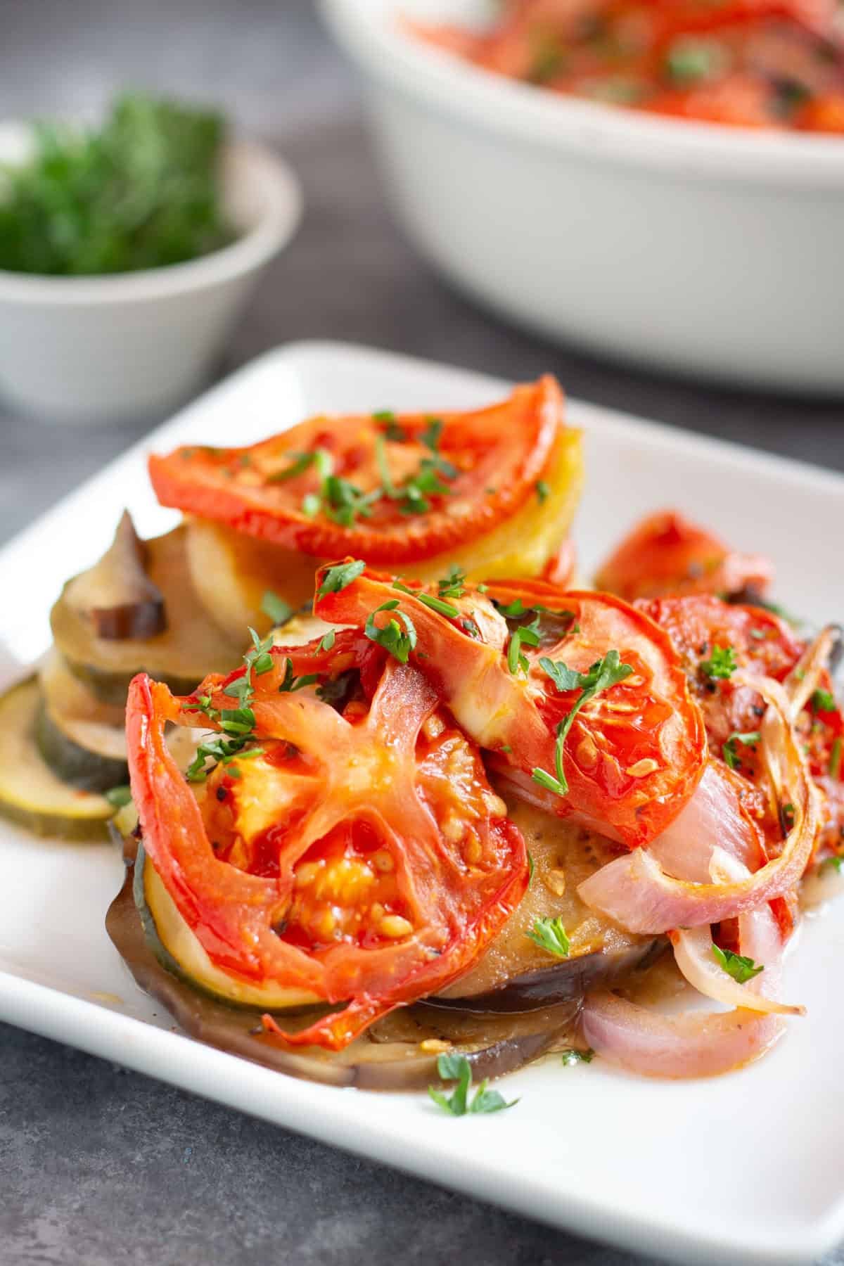 Briam is easy to make and topped with tomatoes and onions. Perfect for a light lunch or dinner. 