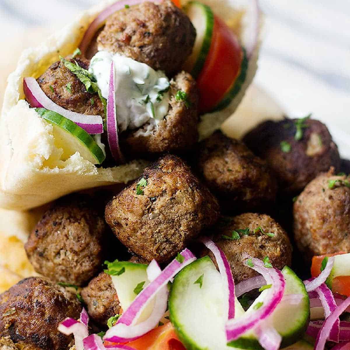 meatballs with vegetables, tzatziki and pita. 