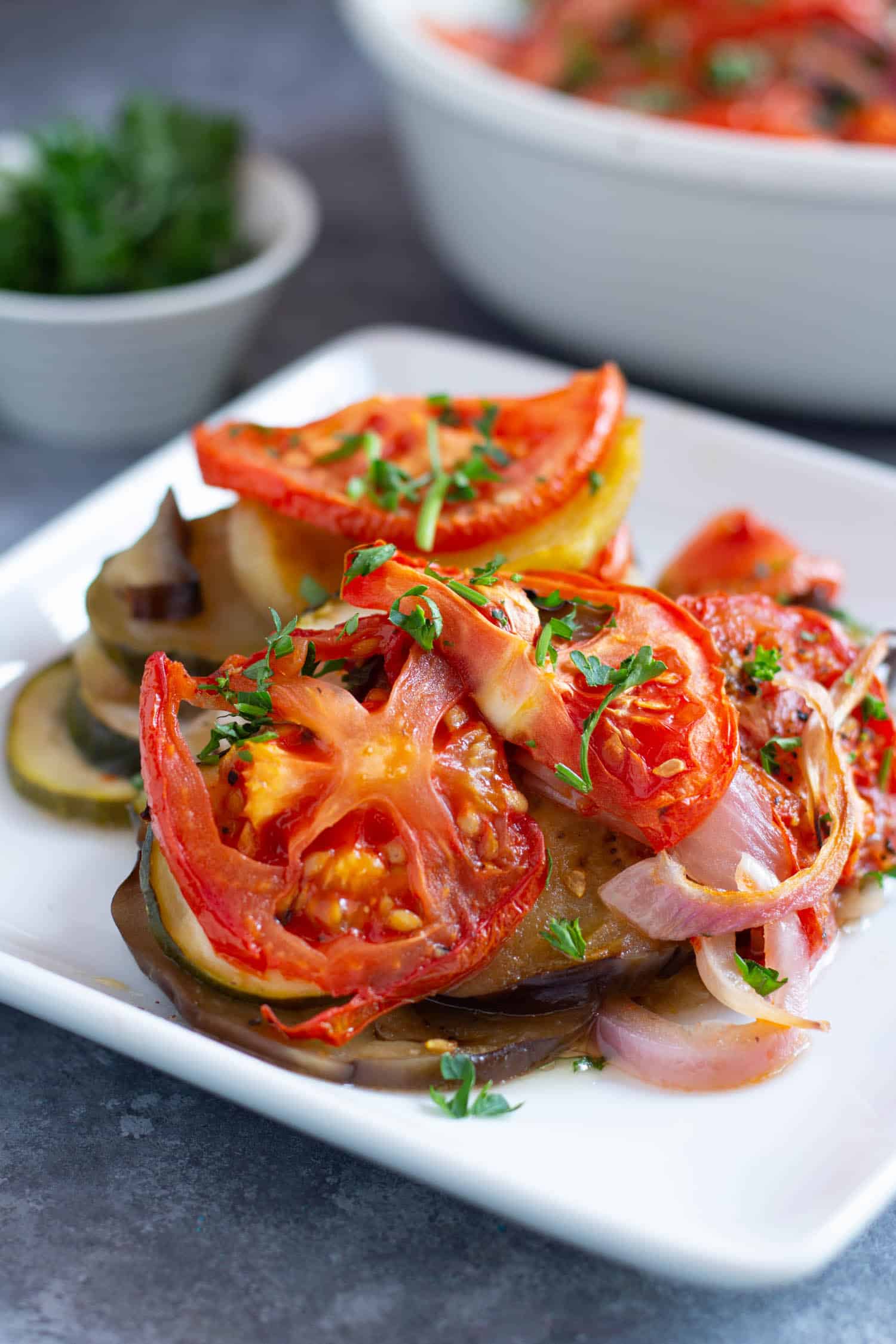 Briam is easy to make and topped with tomatoes and onions. Perfect for a light lunch or dinner. 