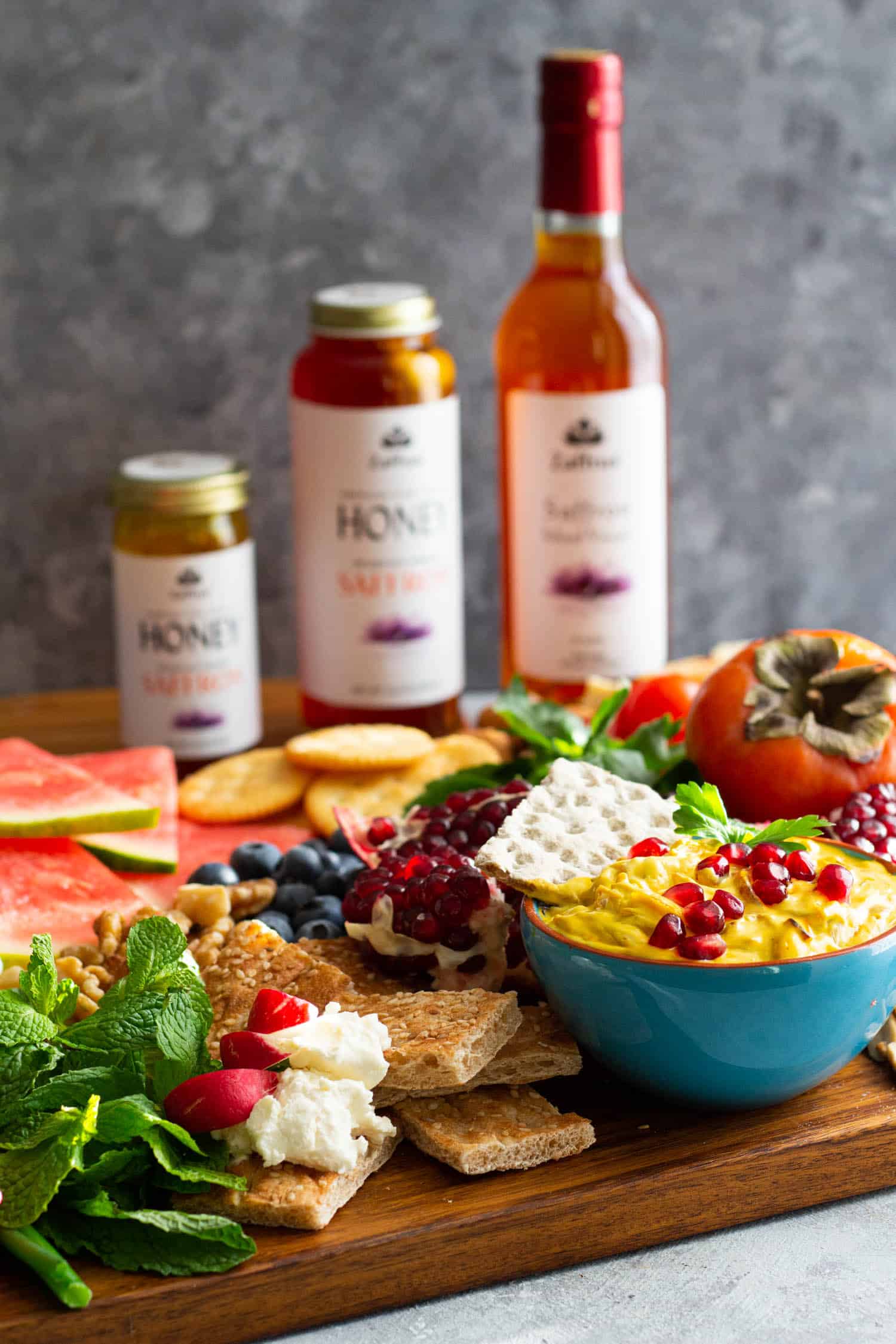 Yalda board has fruit, dip and crackers.