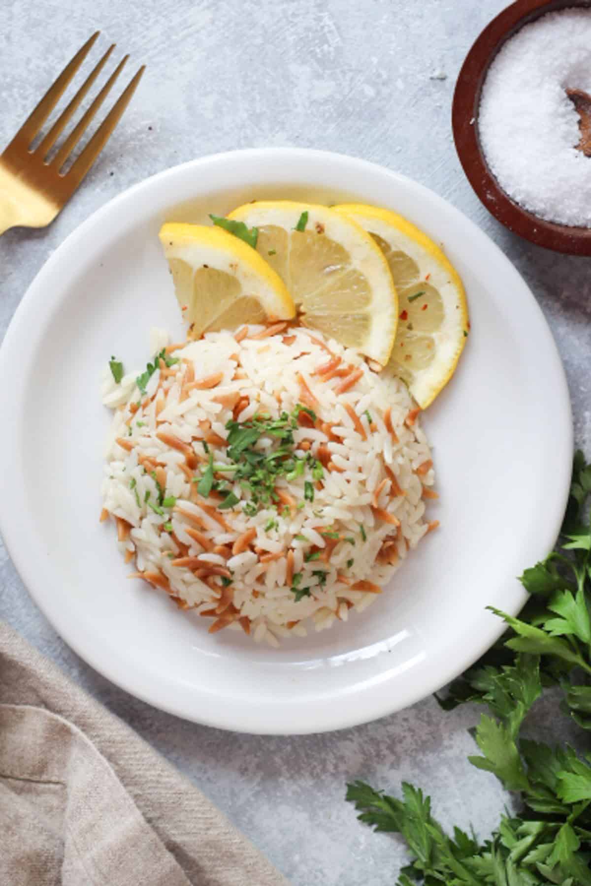 Turkish rice pilaf with orzo served with a few lemon slices. 
