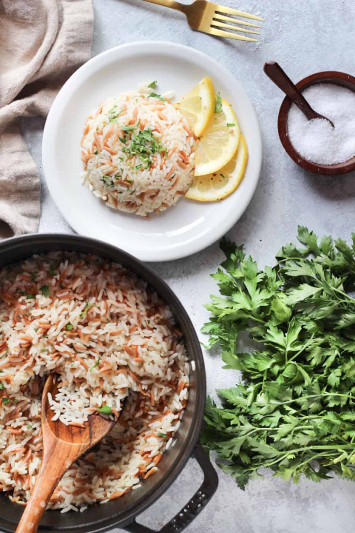 A pot of fluffy rice pilaf and herbs. 
