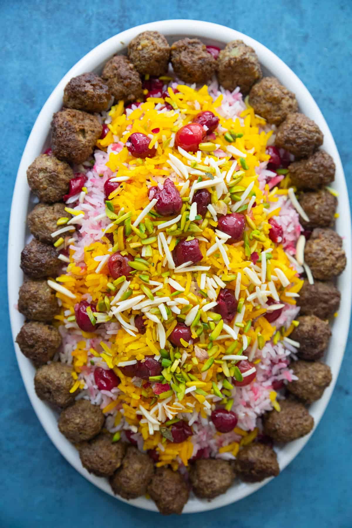 Sour cherry rice with meatballs and saffron rice on top. 