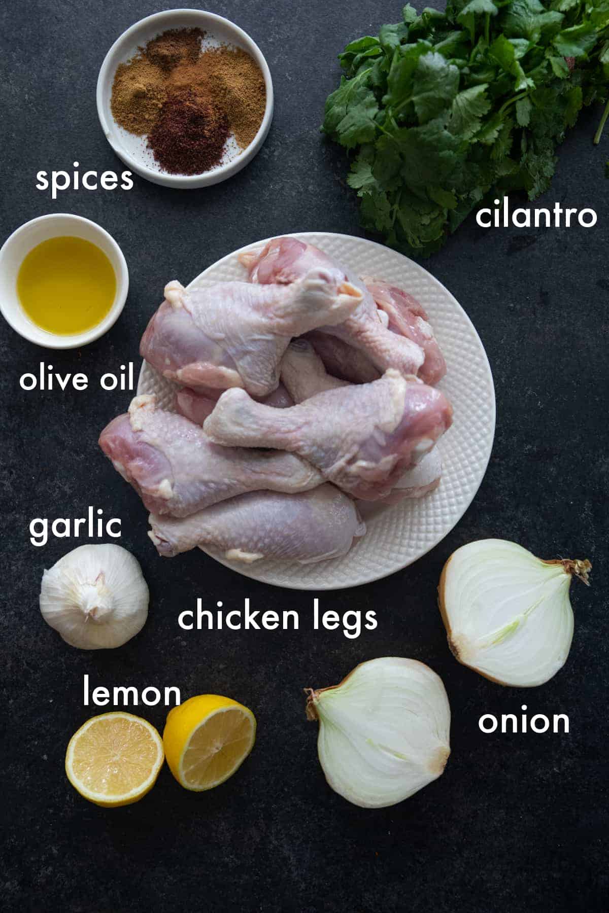 Ingredients to make this recipe are chicken legs, spices, onion, garlic, lemon and cilantro. 