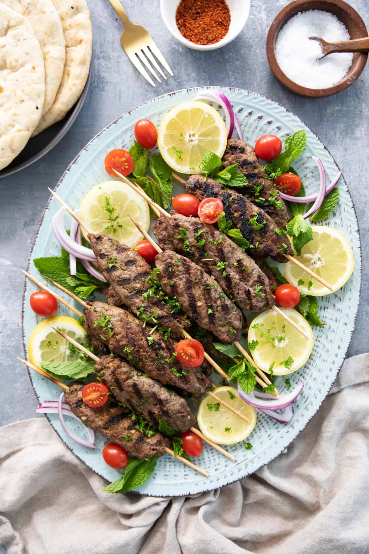 Overhead shot of grilled kofta kebab skewers. 