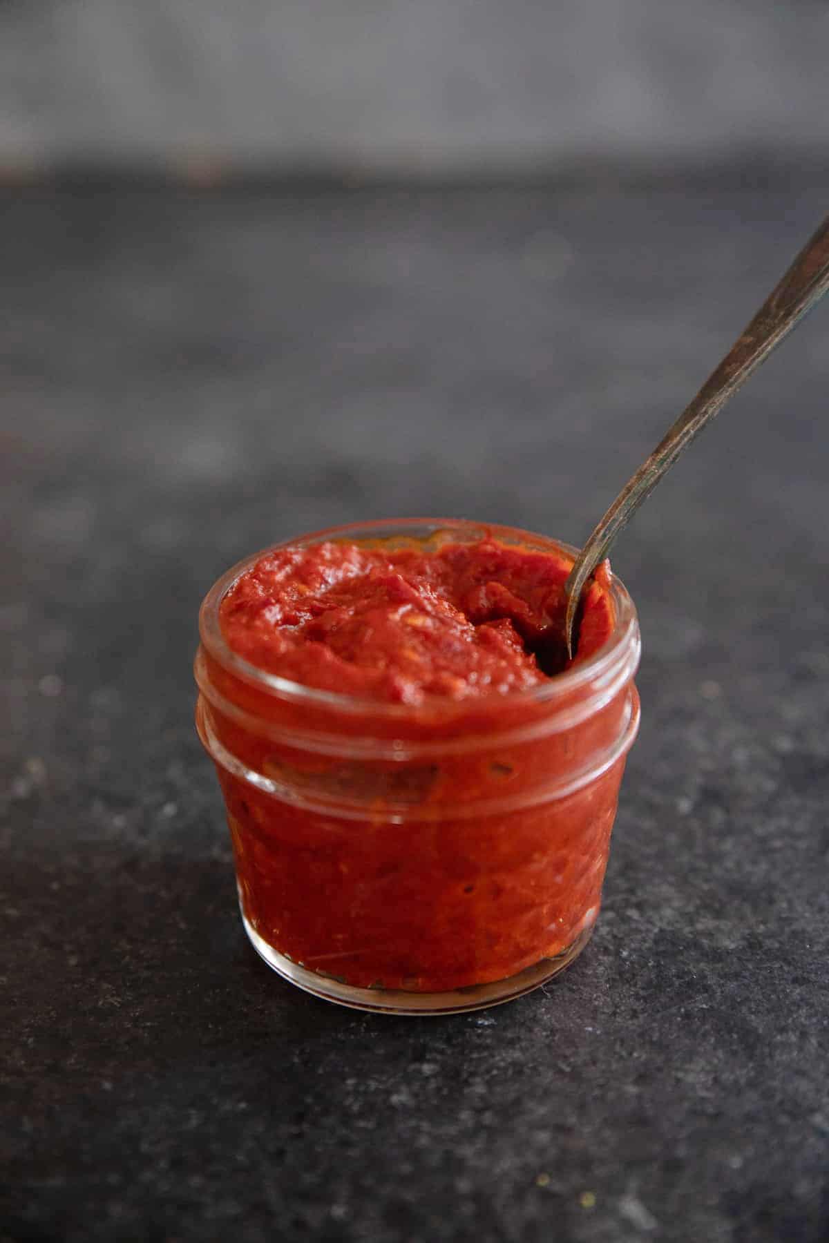 Front shot of harissa paste in a jar.