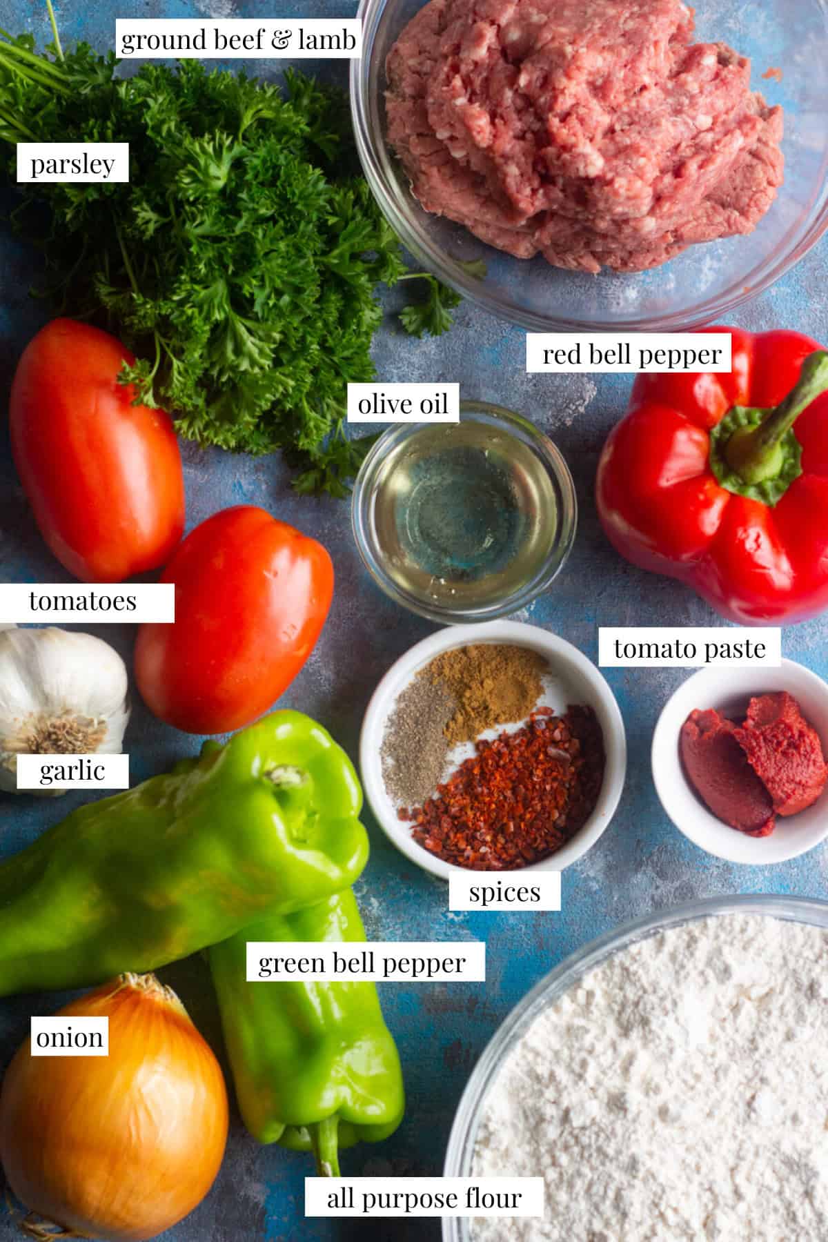 To make lahmacun we need parsley, olive oil, tomatoes. tomato paste, garlic, spices, green and red bell pepper, all purpose flour, onion and ground beef or lamb