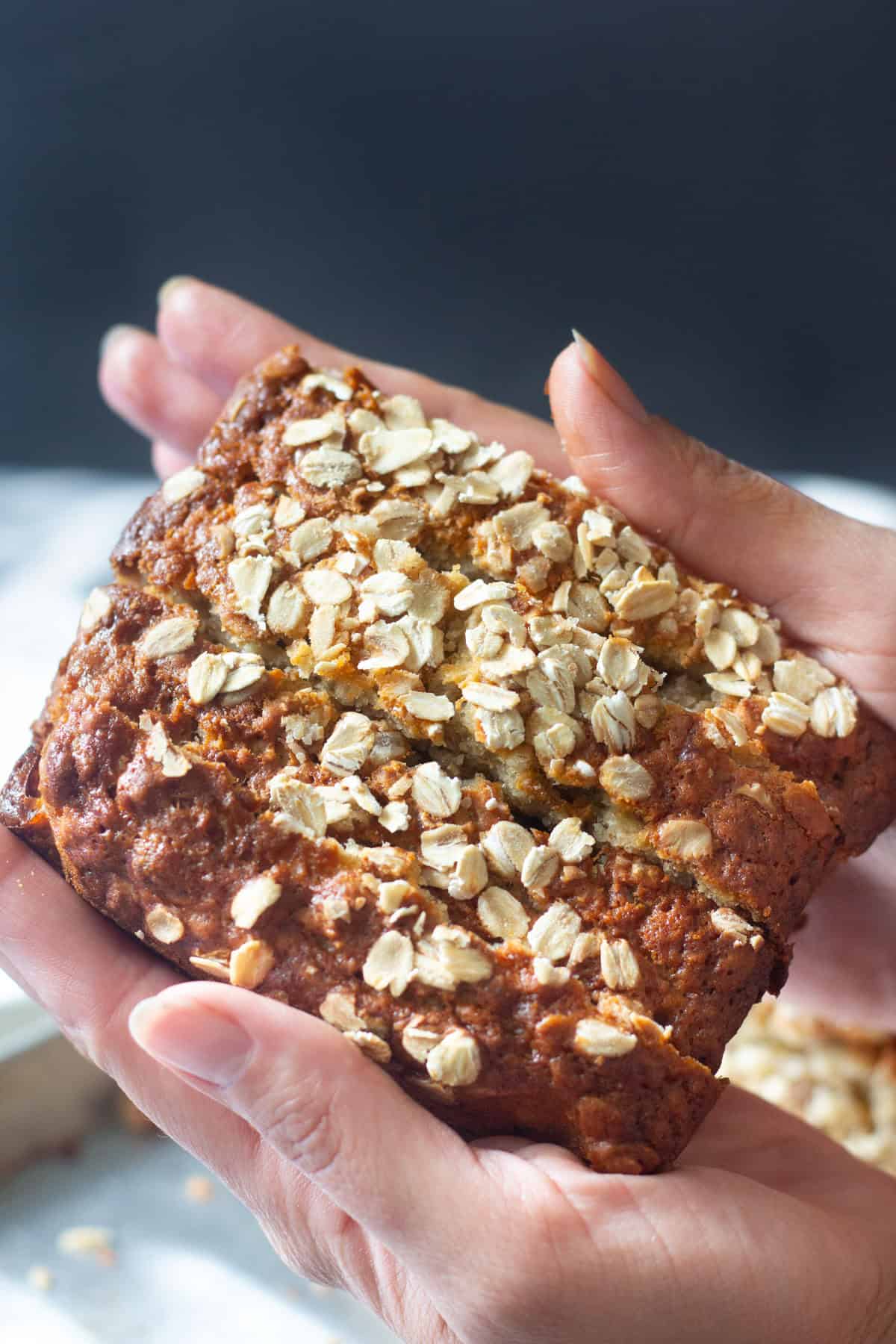 Slices of oatmeal banana bread stacked on each other. 