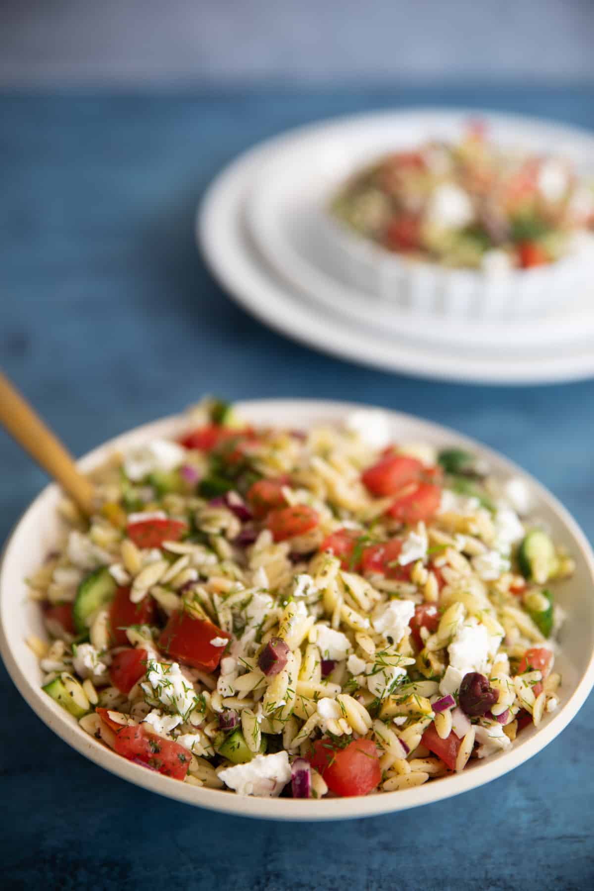 Close up shot of a bowl of orzo pasta salad. 