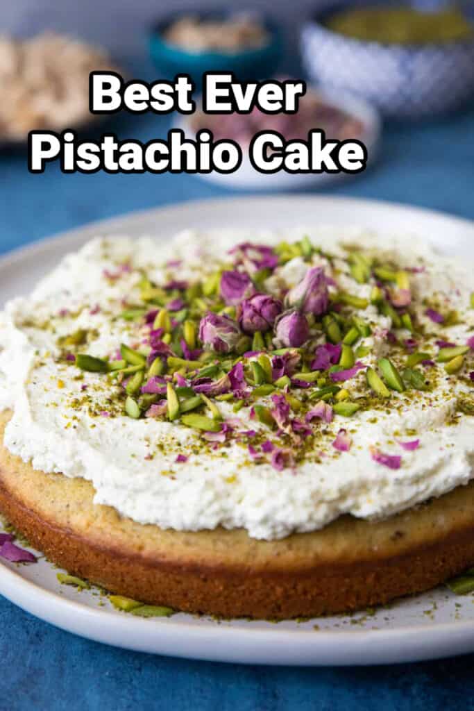 pistchio cake topped with roses and slivered pistachios.