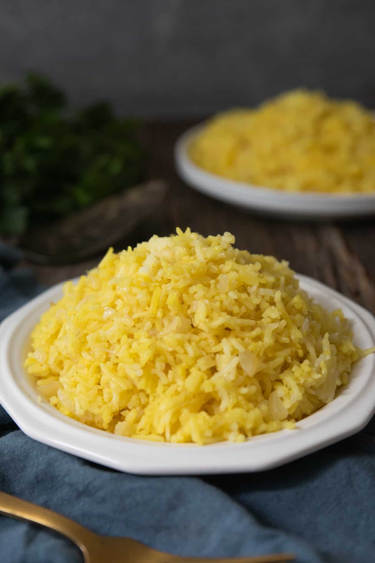 Front shot of saffron rice on a white plate. 