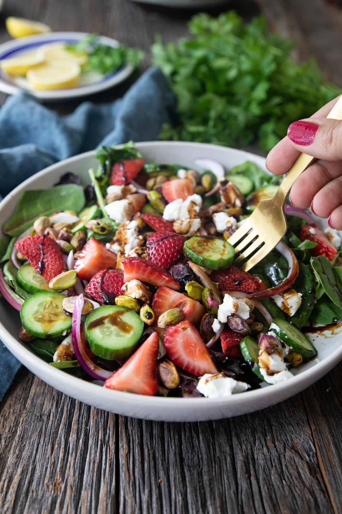 Front shot of strawberry salad with goat cheese and pistachios. 