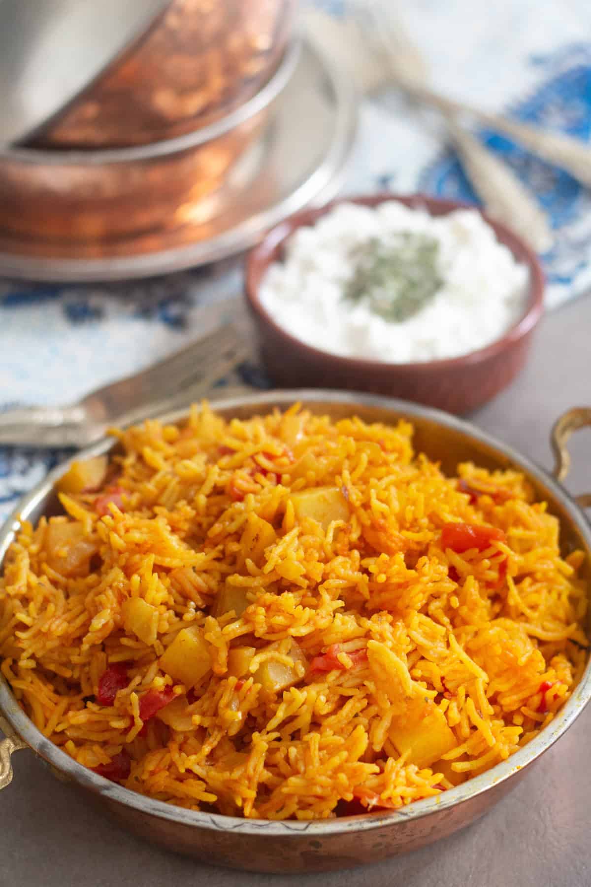 Tomato rice made Persian style and served with salad shirazi and yogurt topped with dried mint. 