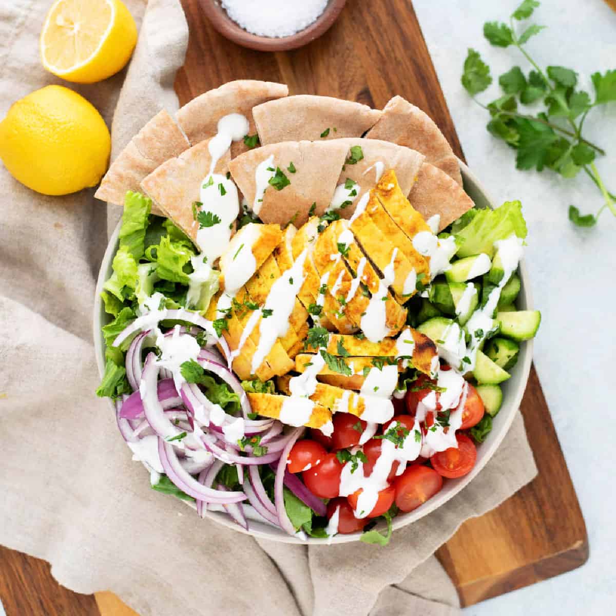 This chicken shawarma salad is easy and delicious. It's loaded with juicy and flavorful chicken, vegetables, and a delicious yogurt sauce! 
