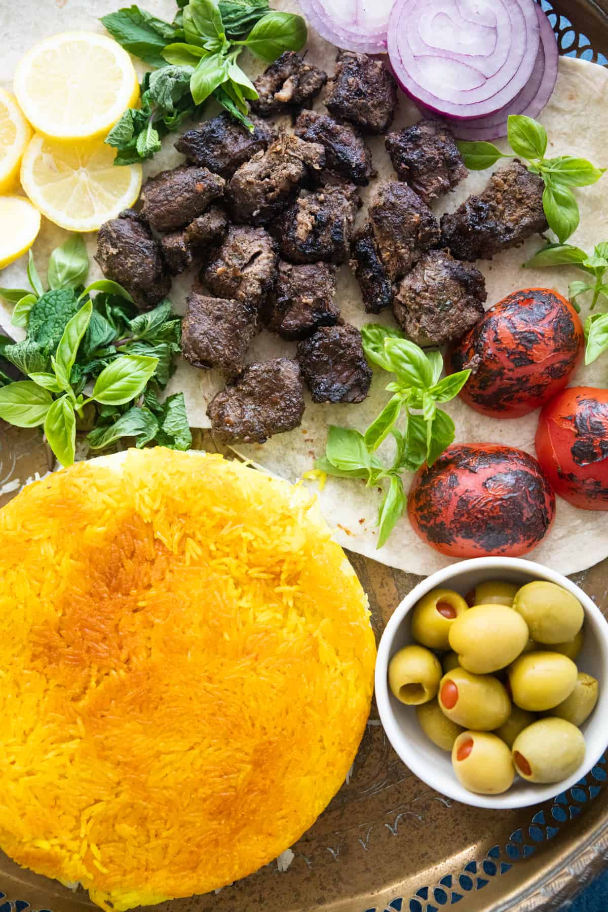 Serve kabob torsh with rice and olives and tomatoes. 