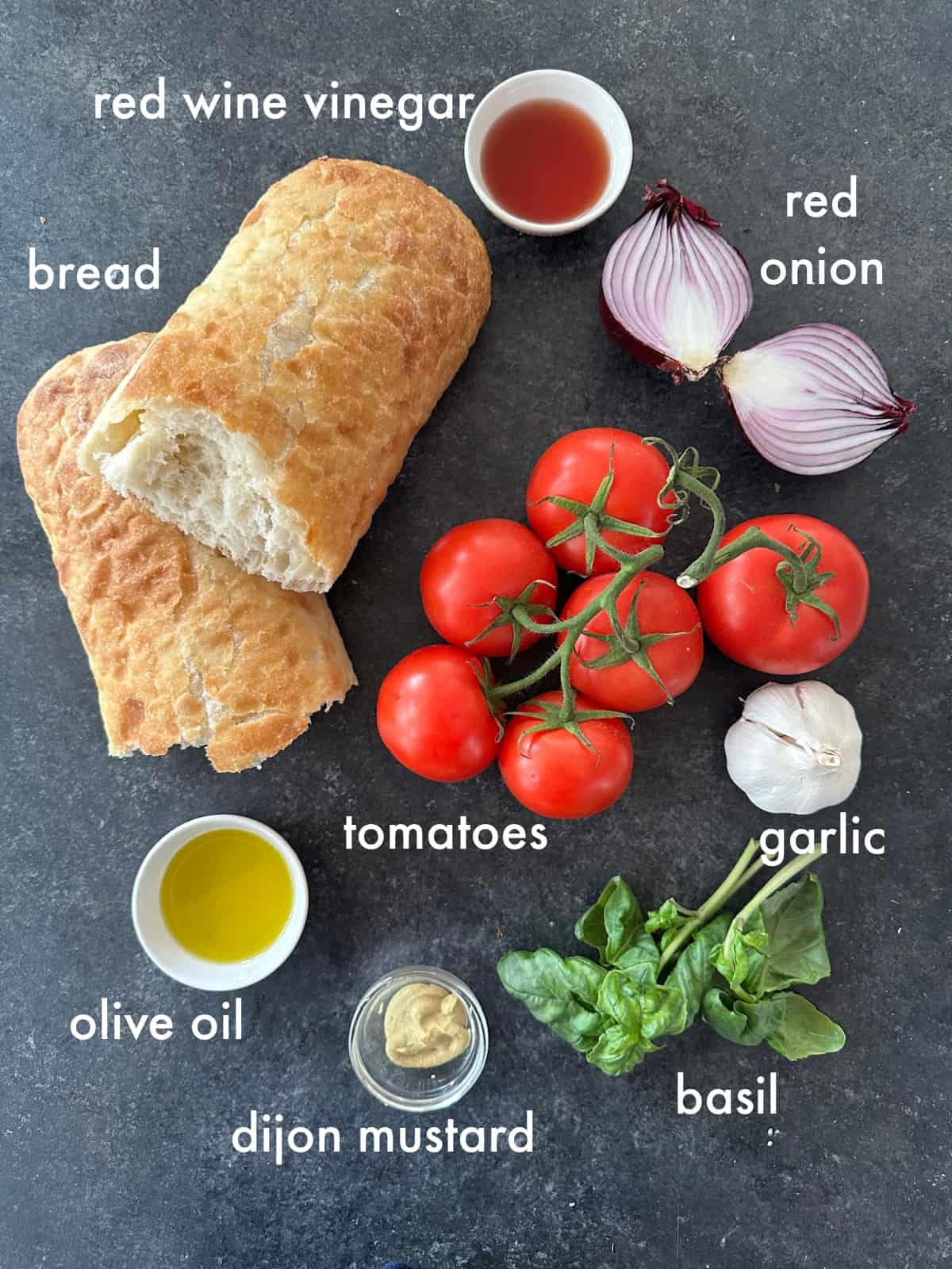 To make this recipe you need bread, tomatoes, onion, garlic, olive oil, vinegar and mustard. 
