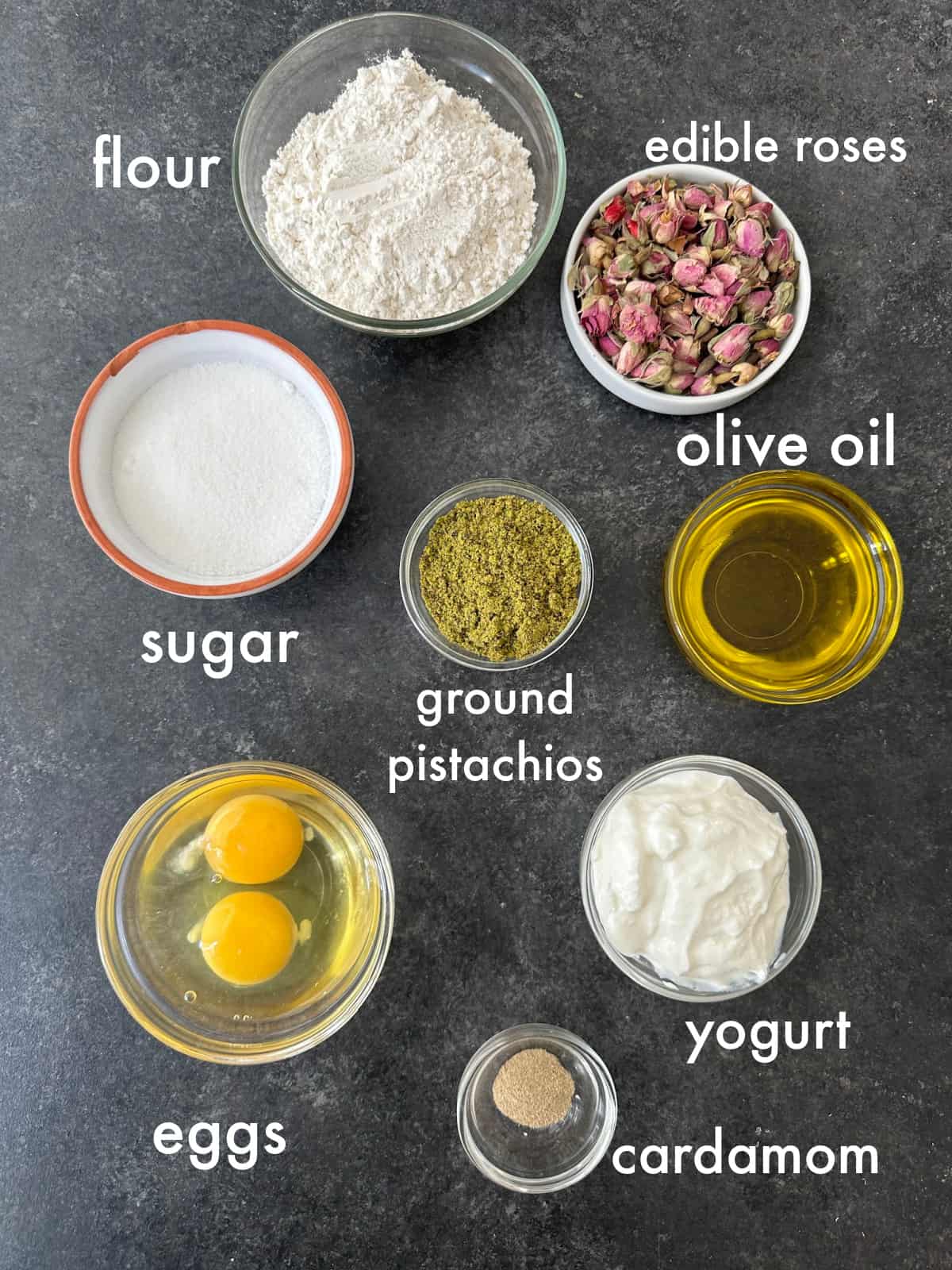 To make this cake you need eggs, sugar, yogurt, cardamom, rosewater, flour, baking powder, baking soda and pistachios. 
