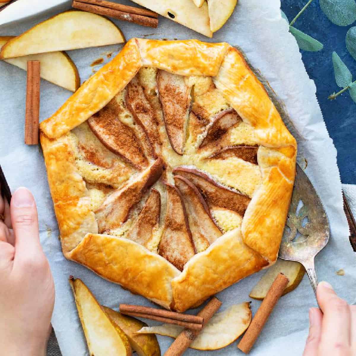 Here's a delicious pear galette flavored with almonds. The flaky crust is filled with creamy almond paste and topped with pear. It's so tasty!
