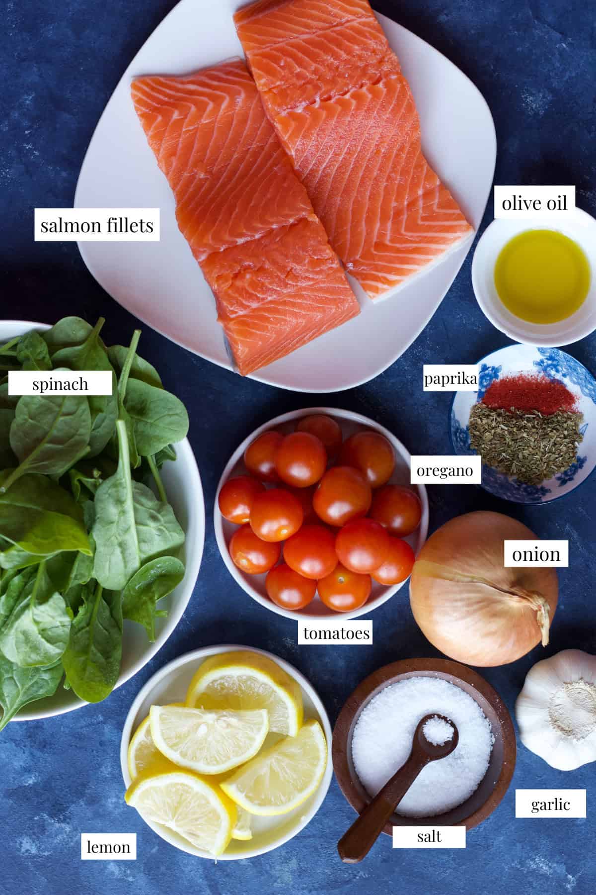 this recipe is made with salmon, lemon, spices, salt, onion, garlic, olive oil, lemon juice, spinach and tomatoes. 