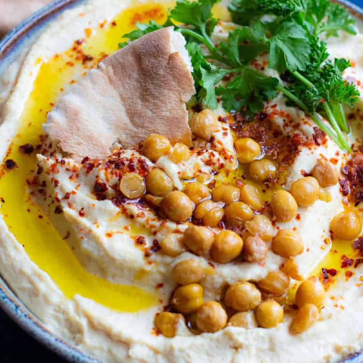 This is the ultimate homemade hummus recipe. It’s smooth and creamy with a bright flavor, and pairs perfectly with bread! Follow along for tip and tricks, a video tutorial and complete details!
