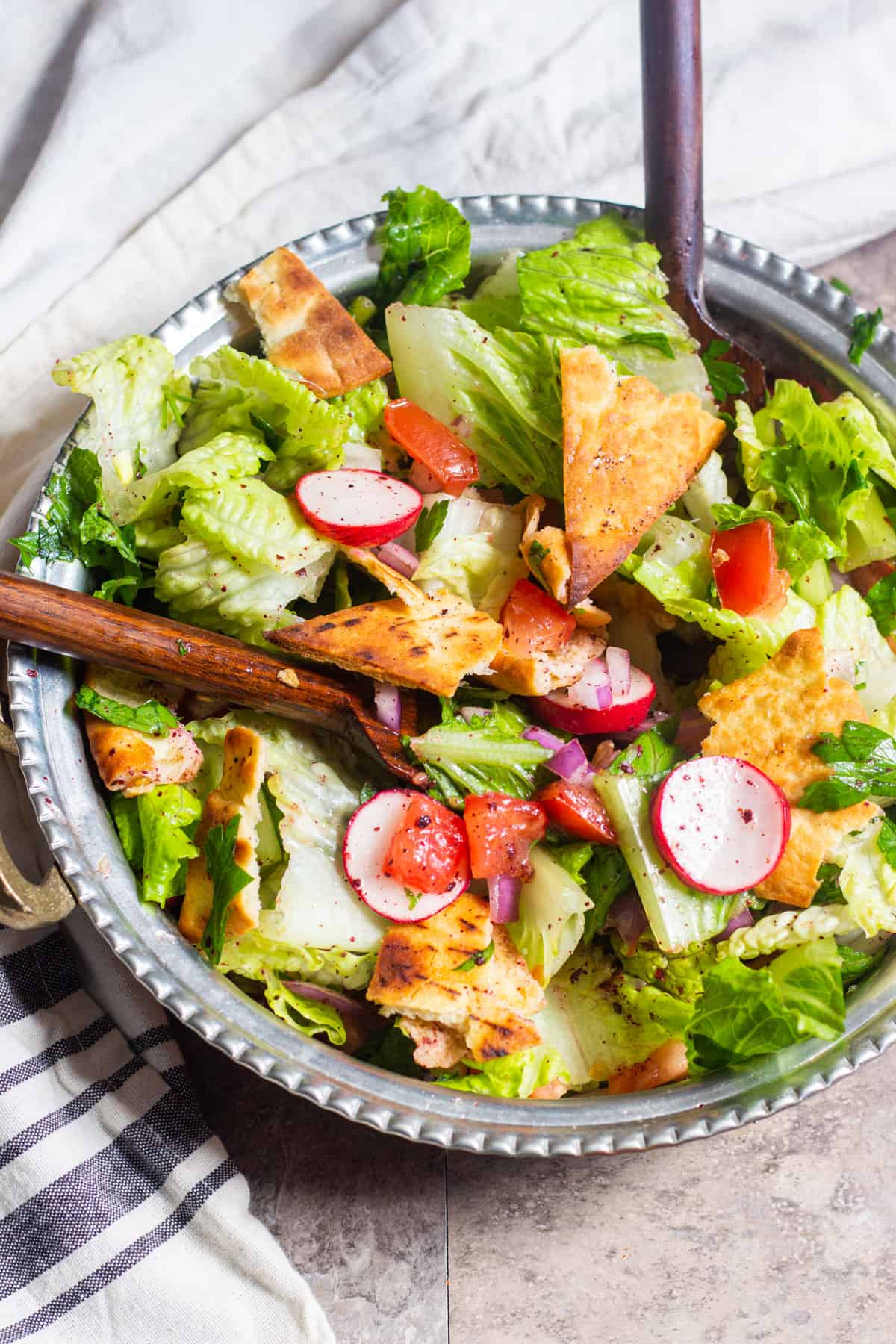 This authentic Lebanese fattoush salad is a Middle Eastern classic. Fresh chopped salad is flavored with crispy toasted pita and a bright, zesty dressing.
