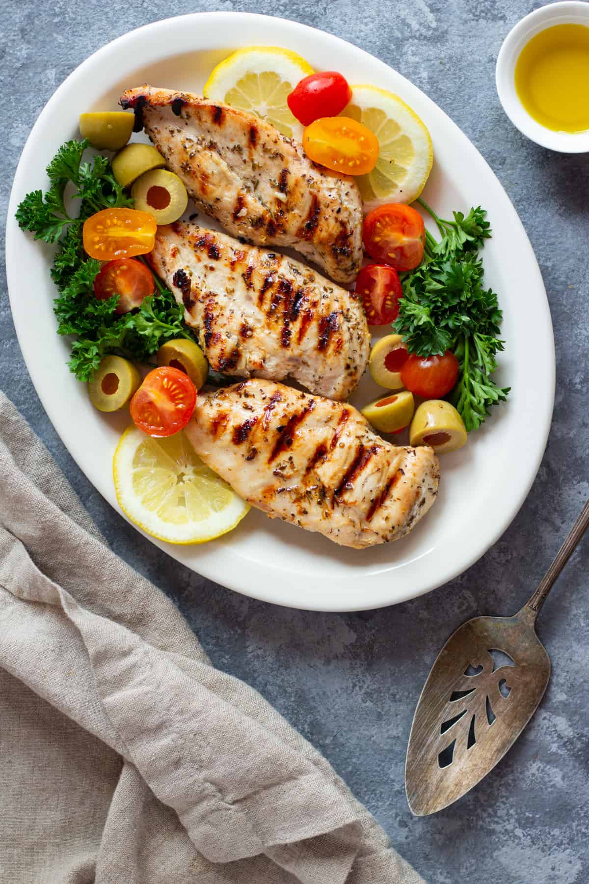 Enjoy the flavors of the Mediterranean with this juicy Greek grilled chicken. The classic marinade is made with lemon, herbs and spices and is so easy to put together!