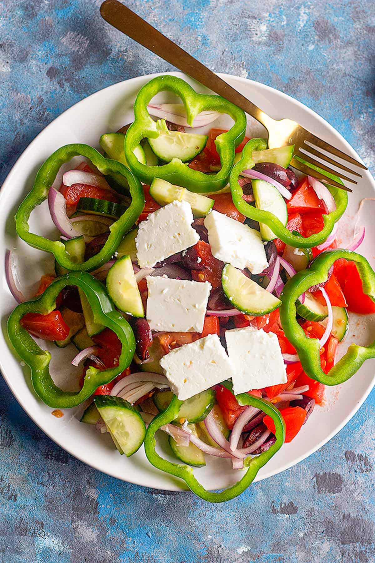 Greek salad has chunks of feta, olives and cucumber.